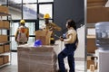 Warehouse workers checking order in parcel and sealing box Royalty Free Stock Photo