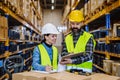 Warehouse workers checking stuff in warehouse with digital system in tablet, holding solar panel. Royalty Free Stock Photo