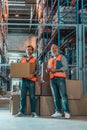 warehouse workers standing with clipboard and box Royalty Free Stock Photo