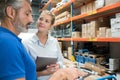 warehouse workers in discussion and holding digital tablet Royalty Free Stock Photo