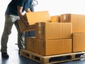 Warehouse Workers Lifting Package Boxes Stack on Pallet. Cartons, Cardboard Boxes. Shipment Boxes, Shipping Supplies Warehouse Royalty Free Stock Photo