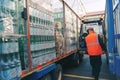 Warehouse workers load a truck with mineral water.