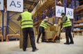 Warehouse workers loading boxes onto pallet jack for efficient order dispatch Royalty Free Stock Photo