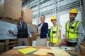 Warehouse workers and managers standing together in warehouse Royalty Free Stock Photo