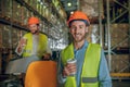 Warehouse workers in orange helmets having coffee break Royalty Free Stock Photo