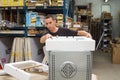 Warehouse workers pack equipment before shipment to customer