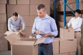 Warehouse workers packing up boxes Royalty Free Stock Photo