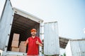 warehouse workers in red smiling with thumbs up Royalty Free Stock Photo