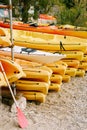 A warehouse of yellow kayaks on the shore. Single kayaks. Rental kayakshop store on sandy beach Royalty Free Stock Photo