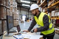 Warehouseman checking delivery, stock in warehouse on computer, pc. Warehouse manager using warehouse management