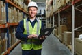 Warehouseman checking delivery, stock in warehouse on laptop. Warehouse manager using warehouse management software, app Royalty Free Stock Photo