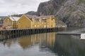Warehouses at stilt quay in inlet harbor, Nusfjord, Lofoten, Norway
