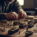 Warfare, strategy, planning, militarization, conquest, army, man at table playing with toy soldiers and tanks Royalty Free Stock Photo