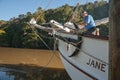 Old fashioned sailing boats moored alongside waterfront pier on Mahurangi River Royalty Free Stock Photo