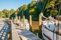 old fashioned sailing boats moored alongside waterfront pier on Mahurangi River Royalty Free Stock Photo