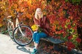 Warm autumn. Girl with bicycle and flowers. Woman bicycle autumn garden. Active leisure and lifestyle. Autumn simple Royalty Free Stock Photo