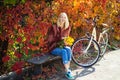 Warm autumn. Girl with bicycle and flowers. Woman bicycle autumn garden. Active leisure and lifestyle. Autumn simple Royalty Free Stock Photo