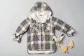 Warm baby coat for boys on gray background top view