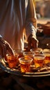 Warm Bedouin hospitality Welcome tea with almonds on a Sinai tray, served by a traditional Egyptian tea waiter