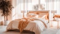 A warm bedroom interior with a bed dressed in soft peach fuzz color bedding and big window. Modern trendy tone hue shade Royalty Free Stock Photo