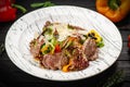 Warm Beef salad with vegetables on white plate Royalty Free Stock Photo