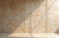 Warm beige marble wall, floor with natural light creating soft shadows. Empty room interior with stone surface, ideal for Royalty Free Stock Photo
