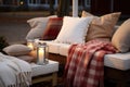warm blankets and pillows assembled for cozy outdoor seating
