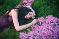 Warm bright colors, sleeping flower sorceress, fairy with wavy dark long hair, delicate wreath, gorgeous purple dress