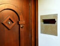 Warm brown pine entrance door with peep hole and stone mail slot