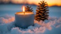 Warm candle flame illuminates snowy winter landscape with pine cones at sunset Royalty Free Stock Photo