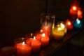 Warm candles in glass jars