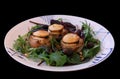 Warm chevre chaud goat cheese baked on rustic bread with green salad and olives. Traditional french dish in close-up