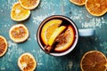 Warm christmas mulled wine or gluhwein with spices and orange slices on wooden teal table top view. Traditional drink on winter. Royalty Free Stock Photo