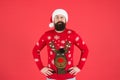 Warm clothes in cold winter weather. holiday season mood. bearded man santa hat red background. merry christmas. ready Royalty Free Stock Photo