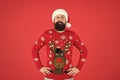 Warm clothes in cold winter weather. holiday season mood. bearded man santa hat red background. merry christmas. ready Royalty Free Stock Photo