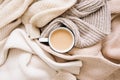 Warm clothes and cup of hot coffee, tea with milk. Autumn mood. The concept of home comfort, cozy mood and winter morning. Royalty Free Stock Photo