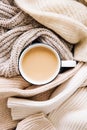 Warm clothes and cup of hot coffee, tea with milk. Autumn mood. The concept of home comfort, cozy mood and winter morning. Royalty Free Stock Photo