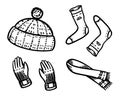 Warm clothes in a doodle vintage style. Winter hat and socks, gloves and a knitted scarf. Engraved hand drawn outline Royalty Free Stock Photo