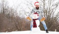Warm clothes. happy hipster ready to celebrate. bearded man build snowman. man santa hat play with snow. winter season