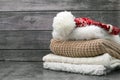 warm clothes on a wooden background. Red hat, white scarf and sweater Royalty Free Stock Photo