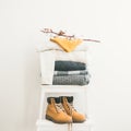 Warm clothing, blankets, boots and cap on chair, square crop Royalty Free Stock Photo