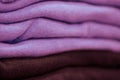 Warm clothing neatly folded on a store shelf. Sweatshirts, sweaters, jumpers, cardigans, hoodies, bobmers with piles on the shelf Royalty Free Stock Photo