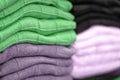 Warm clothing neatly folded on a store shelf. Sweatshirts, sweaters, jumpers, cardigans, hoodies, bobmers with piles on the shelf Royalty Free Stock Photo