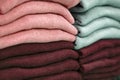 Warm clothing neatly folded on a store shelf. Sweatshirts, sweaters, jumpers, cardigans, hoodies, bobmers with piles on the shelf Royalty Free Stock Photo