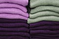 Warm clothing neatly folded on a store shelf. Sweatshirts, sweaters, jumpers, cardigans, hoodies, bobmers with piles on the shelf Royalty Free Stock Photo