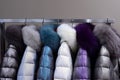 Warm coats with fur collars hanging on rack Royalty Free Stock Photo