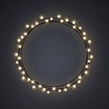 Warm colored Christmas incandescent light string wreath on the dark grey background. Vector outdoor patio lights.