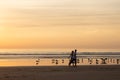 Warm couple walking on beach at sunset Royalty Free Stock Photo