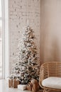 Warm cozy beautiful modern design of the room in delicate light colors decorated with Christmas tree
