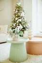 warm cozy beautiful modern design of the room in delicate light colors decorated with Christmas tree and decorative Royalty Free Stock Photo